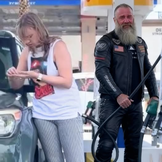 The biker started pumping gas int